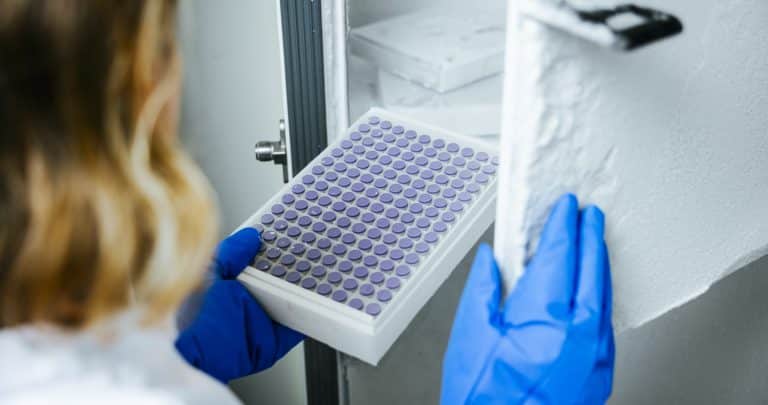 A scientist taking pharmaceutical product from cold storage for headspace analysis
