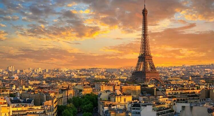 As the sun sets over Paris, casting a warm glow on the Eiffel Tower, one can imagine gathering minds at the Pharma Microbiology Congress nearby, amidst city buildings and a partly cloudy sky.